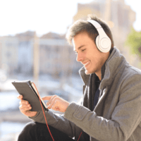 Student with headphones and a tablet